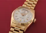 Rolex, An extremely rare, early and historically interesting yellow gold calendar wristwatch with centre seconds, red date, bracelet and highly unusual German script dial