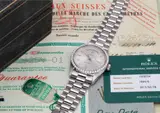 Rolex, A very rare platinum and diamond-set calendar wristwatch with centre seconds, bracelet, rate certificate, guarantee, day-date booklet, swing tags and unusual presentation box