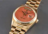 Rolex, An extremely rare yellow gold calendar wristwatch with bracelet, centre seconds and light coral hard stone dial