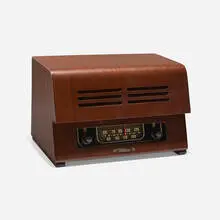 Radio by Charles and Ray Eames, c. 1946, walnut veneer, Bakelite, plastic, enameled aluminum, sold Feb 2024