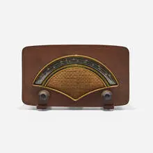 Radio, model 8H034 by Charles and Ray Eames, 1946, walnut veneer, plastic, cloth, sold Feb 2024
