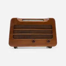 Radio, model 579 by Alexander Girard, c. 1946, walnut, plastic, steel, cloth, glass, sold Feb 2024