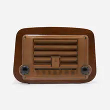 Radio, model 578A by Charles and Ray Eames, 1946, walnut plywood, plastic, Bakelite, sold Feb 2024