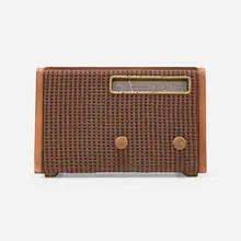 Radio, model 571 by Alexander Girard, 1946-47, walnut plywood, nylon mesh, plastic, sold Feb 2024