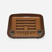 Radio, model 578A by Charles and Ray Eames, 1946, walnut plywood, plastic, Bakelite, sold Feb 2024