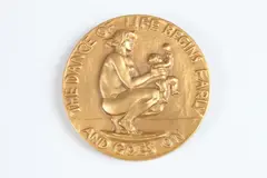 Alexander Stirling Calder, The Dance of Life, Bronze with a patina relief medallion The Society of Medalists 17th Issue-1938 Obverse: A mother and child Reverse: Man, the protagonist, dances with figures representing Pleasure and Pain
