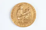 Alexander Stirling Calder, The Dance of Life, Bronze with a patina relief medallion The Society of Medalists 17th Issue-1938 Obverse: A mother and child Reverse: Man, the protagonist, dances with figures representing Pleasure and Pain