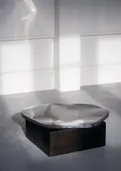 Pol Quadens, Mod. Pebble, Polished stainless steel top and patinated steel base