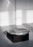 Pol Quadens, Mod. Pebble, Polished stainless steel top and patinated steel base