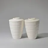 Two vases, model no. 3805 by Keith Murray: Made by Wedgwood, circa 1935, Earthenware, "moonstone" glaze, conical and shouldered form with horizontal ridge decoration, sold Feb 2023