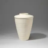 Vase, model no. 3805 by Keith Murray: Made by Wedgwood, circa 1935, Earthenware, "moonstone" glaze, shouldered tapering form with horizontal ridge decoration, sold Feb 2023