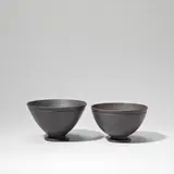 Two footed bowls by Keith Murray: Made by Wedgwood, circa 1935, Earthenware, matt black basalt glaze, sold Feb 2023