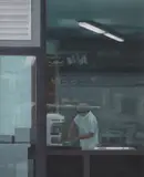 Serban Savu, Untitled (Worker through Shop Window)