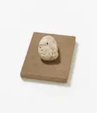 Günther Uecker, Anonym, 1975, Wooden box coated with sand, 1 stone, 3 silkscreens on canvas, 3 imprinted films