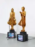 Nam June Paik, Temple guards, 1993, 2 gold-plated wooden sculptures on wooden plinth, painted with acrylic paint verso, 2 monitors, camera on tripod, video on DVD, DVD player. Height of the sculptures including plinth each approx