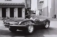 John Dominis, Steve McQueen in black Jaguar at Studio, CA, 1963, Gelatin silver print, printed later