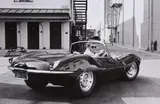 John Dominis, Steve McQueen in black Jaguar at Studio, CA, 1963, Gelatin silver print, printed later
