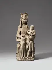 Northern France ca. 1360 & 1380, A Northern French carved limestone figure of the Virgin enthroned, circa 1360/1380., Carved in the round. Minor remains of older polychromy. A figure of the crowned Virgin seated on a moulded throne, holding the Christ Child with the dove of the Holy Spirit on Her left knee and a lily in Her right hand. The sculpture has been designed for a frontal and slightly lowered viewpoint but is carved in the round and therefore viewable from any angle. The Virgin's finely worked features are framed by wavy locks of hair and a veil which falls in symmetrical but flowing folds over her shoulders and back. This same stylised but lively quality is displayed in the finely carved drapery of the Virgin's girded dress, Her cloak and the cloth worn by the Child. Wear with minimal losses
