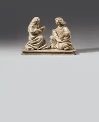 Probably Flemish 15th century, A 15th century presumably Flemish marble Annunciation group., The two figures carved three-quarters in the round, the reverse flattened. Minor remains of former polychromy. The Virgin is shown seated and facing right, holding an open prayer book in Her hands. The correspondingly carved angel Gabriel kneels before Her and holds a baderole above his knees. The angel's wings lost, its left arm reattached. Wear with minor losses. The figures mounted facing each other on a marble plinth. The sculptures each