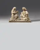 Probably Flemish 15th century, A 15th century presumably Flemish marble Annunciation group., The two figures carved three-quarters in the round, the reverse flattened. Minor remains of former polychromy. The Virgin is shown seated and facing right, holding an open prayer book in Her hands. The correspondingly carved angel Gabriel kneels before Her and holds a baderole above his knees. The angel's wings lost, its left arm reattached. Wear with minor losses. The figures mounted facing each other on a marble plinth. The sculptures each
