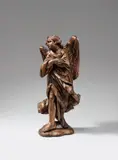 Flemish early 18th century, An early 18th century Flemish carved wooden figure of an angel., Carved in the round, the reverse only provisorily. Minor remains of former polychromy. A figure of an angel facing left. The sculpture's pained expression and folded arms point to a possible original placement as one of a pair of angels flanking the passion of Christ. With minor wear. The plinth subsequently carved from the original substance