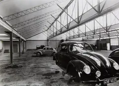 VW-Werkstatt, Firma Hahn, Stuttgart (Architekt Rolf Gutbrod) (VW-Garage, Hahn company, Stuttgart [architect Rolf Gutbrod]) by Franz Lazi, 1949, 2 vintage ferrotyped gelatin silver prints on Agfa paper. Each, offered May 2014