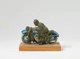 Dieter Roth, Motorradfahrer (motorcyclist), Tin toy, acrylic colour poured over, mounted on wooden base, overall dimension approx