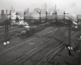 Berenice Abbott, HOBOKEN RAILROAD YARDS LOOKING TOWARDS MANHATTAN, NEW JERSEY