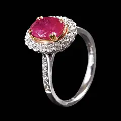 A Burmese Ruby and Diamond Ring in 18k, Untitled, Set in 18k white gold, the ring is centered by an oval-shaped Burmese ruby weighing 1.82 cts. The ruby is accented by a halo of diamonds weighing approximately 0.36 cts with additional diamonds along the band weighing approximately 0.12 carats. <br><br> The piece is accompanied by a GRC Gem Grading Manual No. G2312010101, dated December 1, 2023. <br><br> Weighs 3.30 grams. <br><br> Some stones noted as Refer on the GIA iD100®