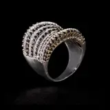 A Diamond Cocktail Ring in 18k, Untitled, The 18k white gold ring is designed with thirteen rows of alternating white and black diamonds in graduating sizes. The white diamonds weigh approximately 0.70 cts and the black diamonds weigh approximately 1.17 cts. <br><br> The piece is hallmarked 18k 750 , RD 0.67 , BD 1.16. <br><br> Weighs 11.10 grams. <br><br> Some stones noted as Refer on the GIA iD100®