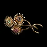 A Classic 18k Floral Brooch, Untitled, The 18k yellow and white gold brooch features three graceful stems with flowers accented by multi-colored stones in a cluster setting.