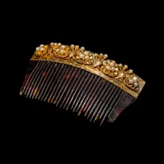 A Payneta Comb, Untitled, The payneta comb crafted in silver and dipped in yellow gold features a delicate floral design accented by seed pearls.