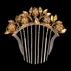 A Payneta Comb, Untitled, The elegant payneta comb, crafted in two-tone gold-plated silver, showcases delicate floral and nature motifs beautifully accented by seed pearls.