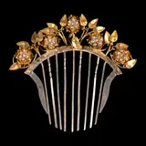 A Payneta Comb, Untitled, The elegant payneta comb, crafted in two-tone gold-plated silver, showcases delicate floral and nature motifs beautifully accented by seed pearls.