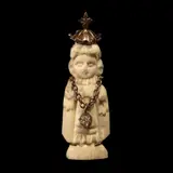 Untitled by A Carved Santo Niño Pendant in Silver, The pendant features a carved image of Santo Nino on bone set in a silver setting., sold Jan 2026
