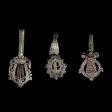 A Set of Silver Châtelaine Clips, Untitled, The set comprises of three silver châtelaine clips designs with intricate floral wreath motifs. <br><br> A châtelaine began as a practical belt hook used by the castle’s lady to suspend her keys. They were made popular in the 17th to the early 20th century. Over time, it evolved into an ornate jewelry piece with multiple chains suspending various accessories.