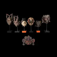 Untitled by Six Masks Mounted on bases, polychromed hardwood, sold Jan 2026