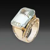 An 18k Cocktail Ring, Untitled, The 18k yellow gold ring features a light blue step-cut rectangular stone set in an east-west orientation, accented by diamonds.
