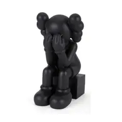 Untitled by Kaws, black painted cast vinyl, sold Jan 2022