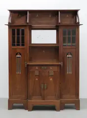 Vienna School, Seccessionist cabinet, circa 1900, Oak, glass and with a bevelled mirror, decorated with stylised arrow motifs in ivory, ebonised wood and pewter inlay