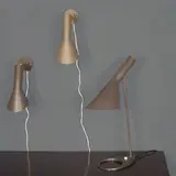 Arne Jacobsen, Ensemble comprenant deux appliques et une lampe de table mod. "AJ", An 'AJ' set of two sconces and a table lamp by Arne Jacobsen in lacquered metal designed in 1957 and edited by Louis Poulsen