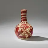 Small bottle vase by William De Morgan, 1885, Earthenware, ruby lustre glaze, decorated with stylised foliage and stripes to neck, sold Dec 2023