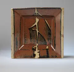 Shoji Hamada, Square dish, Stoneware, mottled persimmon over cream glazes with wax resist stem leaf design