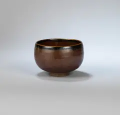 Early tea bowl by Bernard Leach, circa 1935, Stoneware, rich lustrous red brown glaze with dark mottling, sold Dec 2023