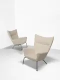Hans J. Wegner, Pair of high-backed wing armchairs, model no. CH445, designed 1960, produced circa 2006, Stainless steel, fabric upholstery