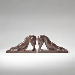 H. Rical, Pair of Art Deco 'dog' bookends, circa 1930, Patinated bronze, each cast from a model as a stretching 'Borzoi' hound, integral bronze base