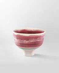 Lucie Rie, Footed bowl, circa 1978, Porcelain, vivid pink glaze with inlaid lines, turquoise band