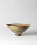 Footed bowl by Lucie Rie, circa 1974, Stoneware, pale green and brown pitted volcanic glaze, sold Apr 2023