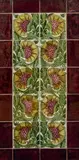 Ten-Tile Floral Panel by William De Morgan, painted with flowers with ruffled petals, glazed earthenware, surrounded by border tiles, framed, offered Dec 2023