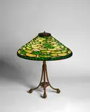 'Lily Pad' Table Lamp by Tiffany Studios, patinated bronze, leaded glass, base and shade each stamped 'Tiffany Studios New York', sold Dec 2023